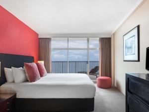 a hotel room with a bed and a large window at BreakFree Imperial Surf in Gold Coast +29 photos