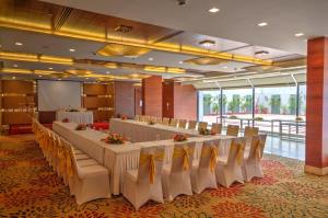 a conference room with a long table and chairs at Dolphin Hotel in Visakhapatnam