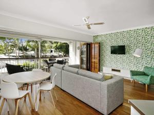a living room with a couch and a table at Mantra on the Inlet in Port Douglas