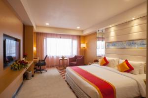 a hotel room with a large bed and a television at Dolphin Hotel in Visakhapatnam