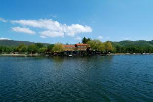 a house on the shore of a large lake at Hotel La Bella Venere in Caprarola