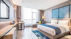 Ένα ή περισσότερα κρεβάτια σε δωμάτιο στο Echarm Hotel Torch Development Zone Zhongshan Station