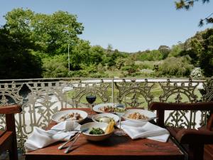 a wooden table with bowls of food on a balcony at Peppers Craigieburn Resort in Bowral