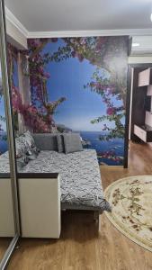 a bedroom with a mural of a tree and a bed at Пункт Пересадки in Chişinău