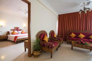 a hotel room with a bed and a mirror at Dolphin Hotel in Visakhapatnam