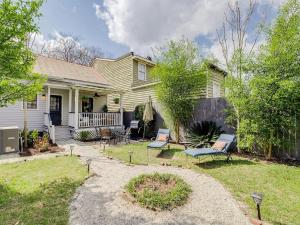 a house with a yard with chairs and a patio at Waldburg Cottage in Savannah