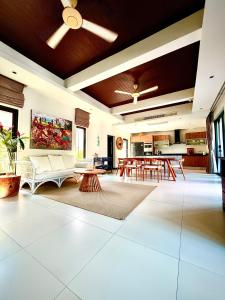 a living room with a couch and a table at Phuket Hideaway Near Bang Tao in Laguna Phuket