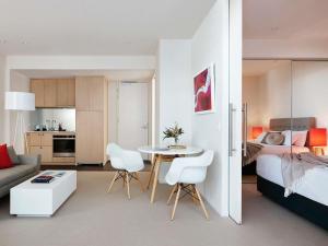 a living room with a bed and a table and chairs at Art Series - The Watson in Adelaide