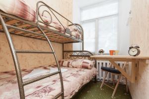 a bedroom with a bunk bed and a desk and a desk at Winterfell on Smolenskaya in Moscow