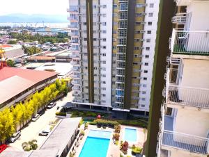 an aerial view of a building with a swimming pool at Convenient Condo - Nearby CDO Mall in Pontud