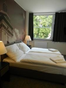 A bed or beds in a room at Hotel Bílý Páv