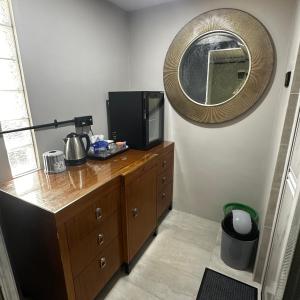 a room with a dresser with a tv and a mirror at Orchid Cabin Kuala Tahan in Kuala Tahan