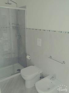 a white bathroom with a toilet and a shower at Villa Belvedere Salento in Porto Cesareo