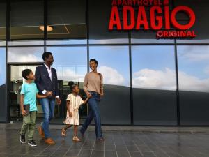 a group of people walking in front of aadobeadobeadobeadobeadobeadobeadobe at Aparthotel Adagio Abidjan Marcory in Abidjan +62 photos
