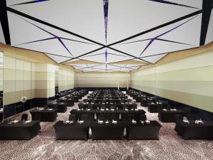a large banquet hall with black tables and chairs at Novotel New Delhi City Centre in New Delhi +94 photos