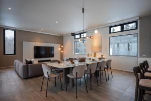 a dining room with a large table and chairs at Mokuren by H2 Life in Niseko