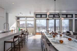 a dining room with a long table and chairs at Mokuren by H2 Life in Niseko +8 photos