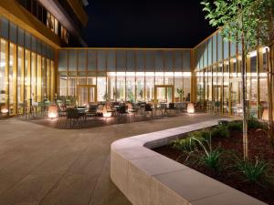 a lobby of a building with tables and chairs at Novotel Zagreb in Zagreb