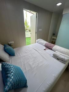 a large white bed with pillows on top of it at Cosy and Comfortable Cottage in South Delhi in New Delhi