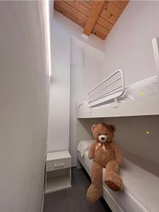 a teddy bear sitting on a bunk bed at NALI Apartment 2 in Civitanova Marche