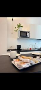 a kitchen with a table with a plate of food at NALI Apartment 2 in Civitanova Marche +8 photos