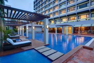 a swimming pool in front of a building at Dolphin Hotel in Visakhapatnam