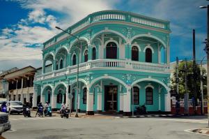a blue and white building on a city street at XXNEW GO INN Seng Ho Phuket - โอลทาวน์ Oldtown in Phuket Town