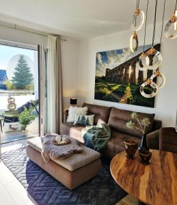 a living room with a couch and a table at Self Check-in-Kostenfreier Parkplatz-Ruhig&Modern-Balkon in Niedernberg