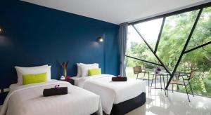 a room with three beds and a large window at The Forest Home Resort in Ban Dong +167 photos