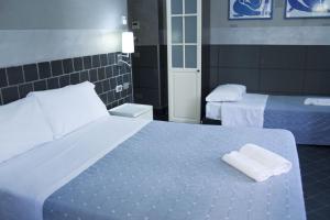 Postel nebo postele na pokoji v ubytování Hotel Agorà