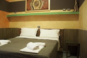 Postel nebo postele na pokoji v ubytování Hotel Agorà