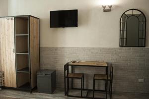 TV a/nebo společenská místnost v ubytování Hotel Agorà