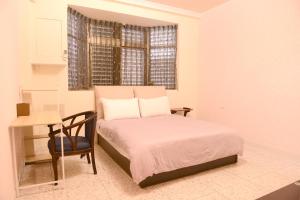 Ένα ή περισσότερα κρεβάτια σε δωμάτιο στο 法頌休閒民宿