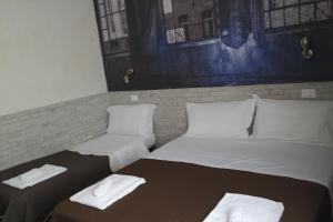 Postel nebo postele na pokoji v ubytování Hotel Agorà