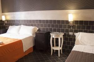 Postel nebo postele na pokoji v ubytování Hotel Agorà