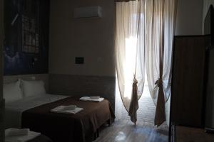 Postel nebo postele na pokoji v ubytování Hotel Agorà