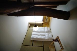 an overhead view of a room with a white bed at Ryokan Tori in Kyoto