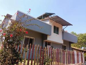 a house with a fence in front of it at Naksh Villa in Mahabaleshwar
