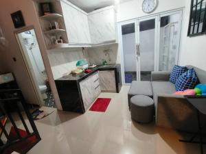 a living room with a couch and a kitchen at Kira Villa in Tlekung