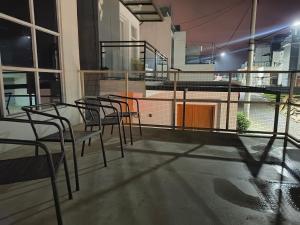 a group of chairs sitting on top of a balcony at Kira Villa in Tlekung