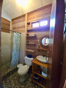 a small bathroom with a toilet and a sink at La posada de Mary in Montañita +49 photos