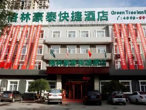 un bâtiment avec un panneau indiquant une auberge arborée verte dans l'établissement GreenTree Inn Langfang GuAn County Xinyuan Street Express Hotel, à Gu'an