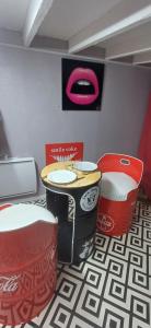 a room with a table and two red chairs at studio love et detente in Saint-Philbert-sur-Risle +1 photo