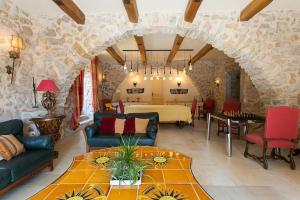 a large living room with a stone wall at Villa sur Golf Opio Valbonne in Opio