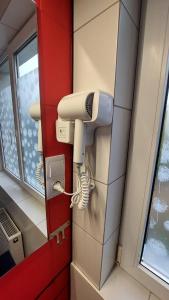 a room with a hair dryer in a bathroom at Hortensja 309 in Koszalin