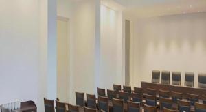 an empty room with chairs and a table and a podium at Changshu Please Hotel in Changshu