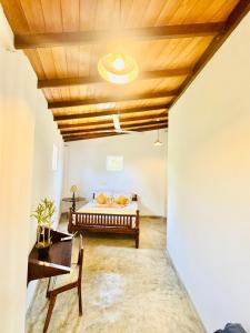 a bedroom with a bed and a wooden ceiling at Coastal Cloud Surf - Walk To Dewata Beach in Unawatuna