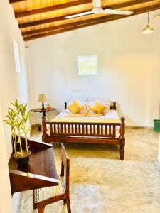a bedroom with a bed with yellow pillows and a table at Coastal Cloud Surf - Walk To Dewata Beach in Unawatuna +57 photos
