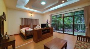 - un salon avec un lit et une télévision dans l'établissement Rommai Reunngam Resort, à Ban Chang Kham Luang