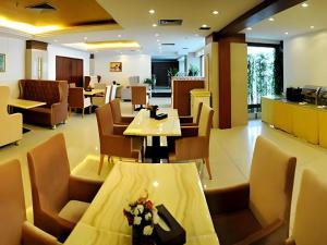 un restaurant avec une table, des chaises et une table dans l'établissement Vienna Hotel Shanxi Taiyuanfu West Street, à Taiyuan